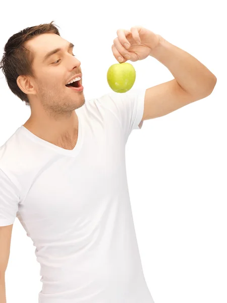 Man in wit overhemd met groene apple — Stockfoto