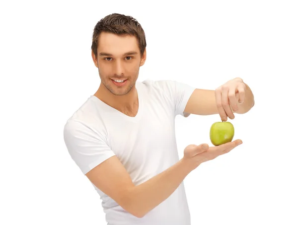 Man in white shirt with green apple — Stock Photo, Image