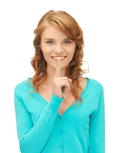 Teenage girl with finger on lips — Stock Photo, Image