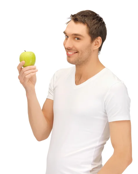 Man in white shirt with green apple — Stock Photo, Image