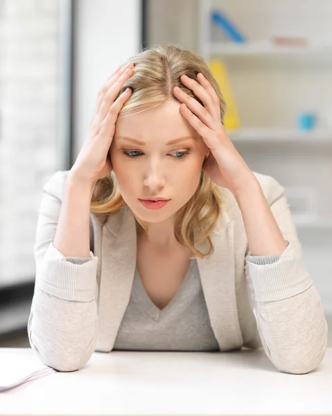 Unhappy woman in office Royalty Free Stock Photos
