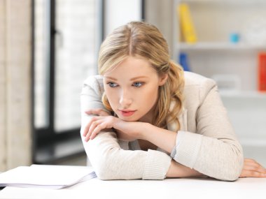 Unhappy woman in office clipart