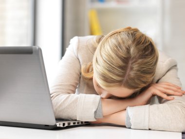Tired woman with laptop computer clipart