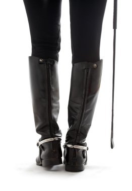 Beautiful legs in black leather horseman boots with riding-crop clipart