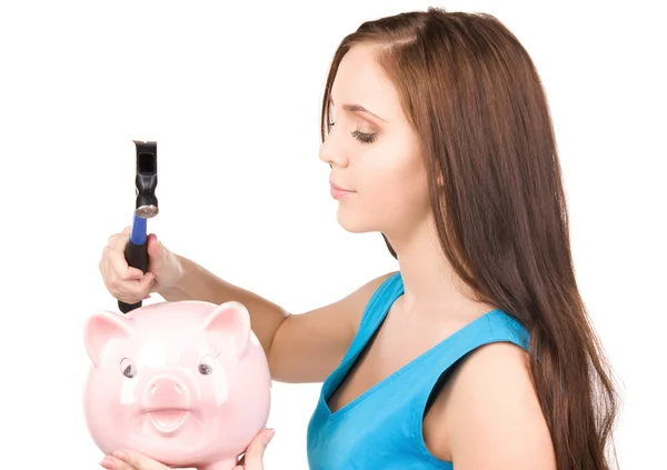 Teenage girl with piggy bank and hammer — Stock Photo, Image