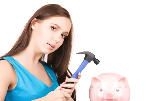 Teenage girl with piggy bank and hammer — Stock Photo, Image