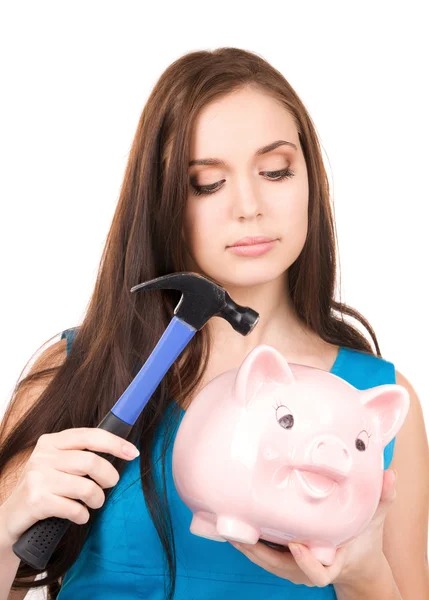 Teenage girl with piggy bank and hammer Stock Photo