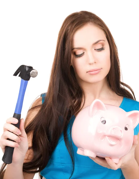 Teenage girl with piggy bank and hammer Stock Image