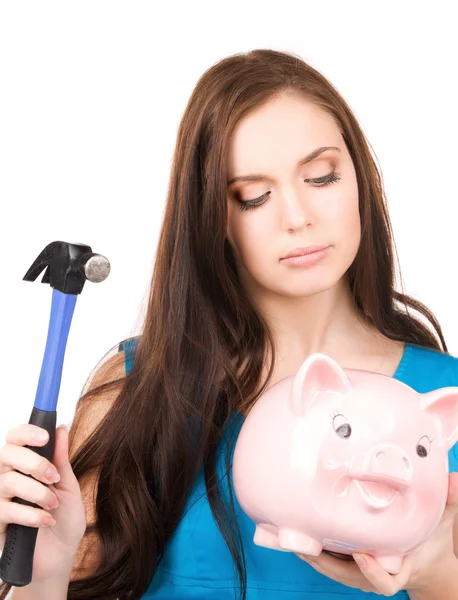 Teenage girl with piggy bank and hammer Royalty Free Stock Photos