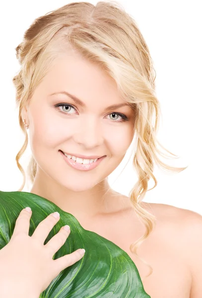 Woman with green leaf Stock Image