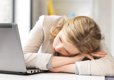 Tired woman with laptop computer clipart