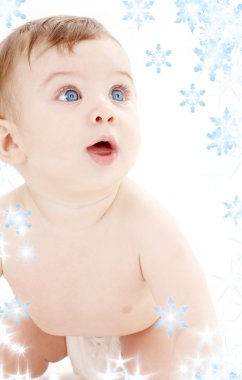 Portrait of crawling baby boy looking up clipart