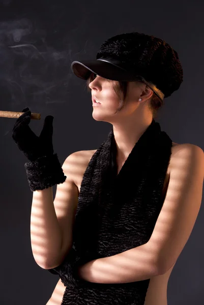 Mulher em preto astrakhan fumar charuto — Fotografia de Stock