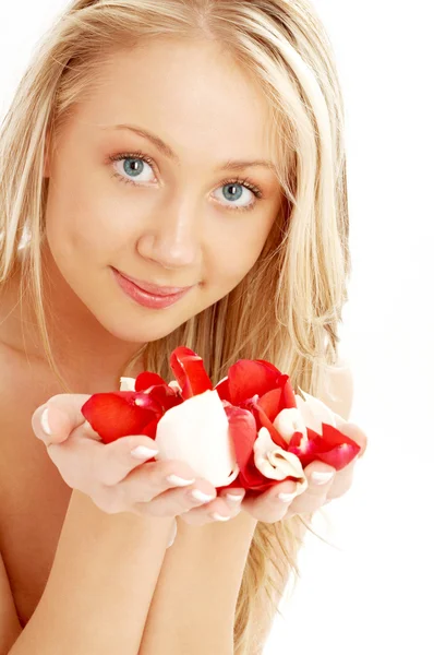 Happy blond in spa with red and white rose petals — Stock Photo, Image
