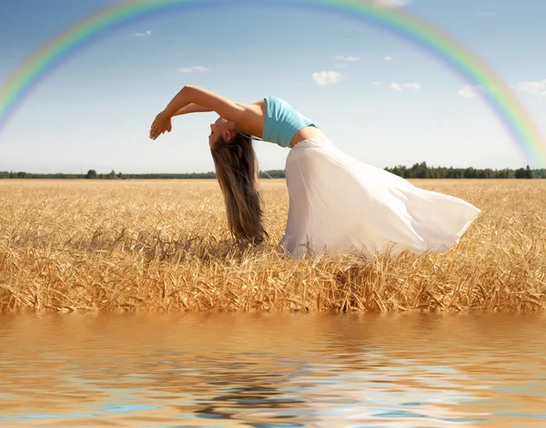 stock image Stretching woman with rainbow and water