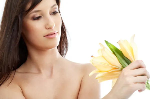 Happy brunette with yellow lily flowers — Stock Photo, Image