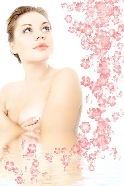 Clean lady in water with flowers — Stock Photo, Image