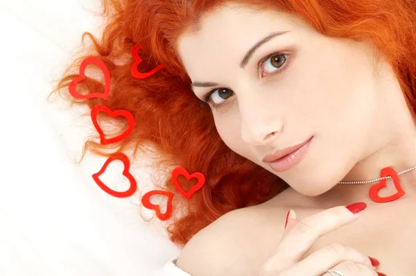 Romantic redhead with read hearts — Stockfoto