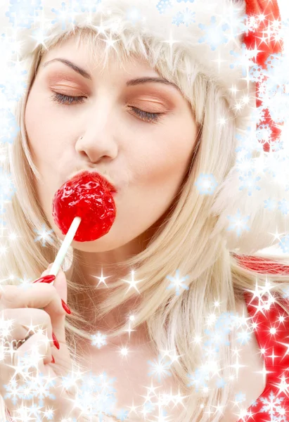 Santa helper med lollipop och snöflingor — Stockfoto