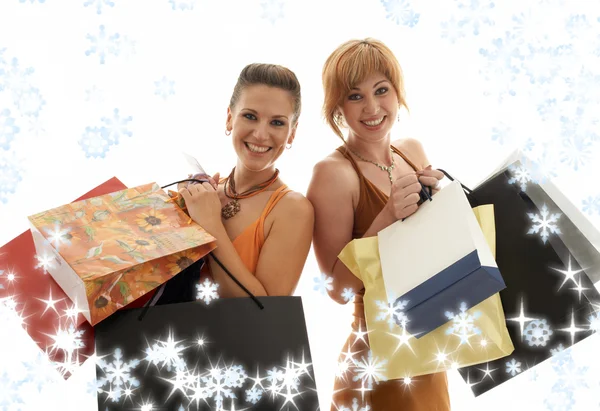 Shopping flickor med snöflingor — Stockfoto
