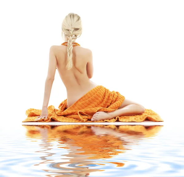Beautiful lady with orange towels on white sand — Stock Photo, Image