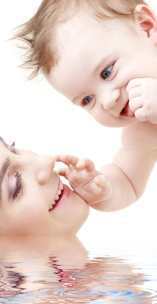 Happy blue-eyed baby boy touching mama — Stock Photo, Image
