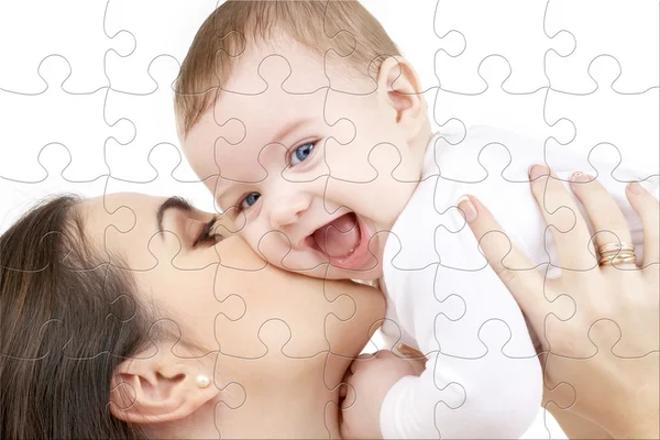 Laughing baby playing with mother puzzle