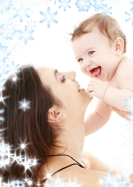 Laughing blue-eyed baby playing with mom — Stock Photo, Image