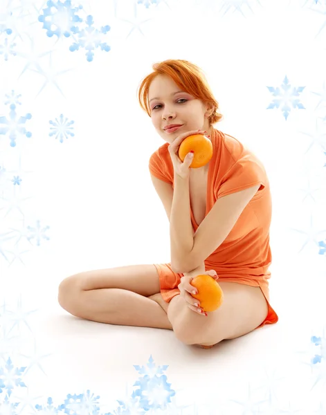 Cheerful redhead with two oranges — Stock Photo, Image