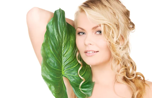 Woman with green leaf Stock Image