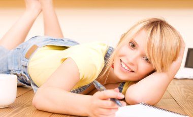 Teenage girl with notebook and pen clipart