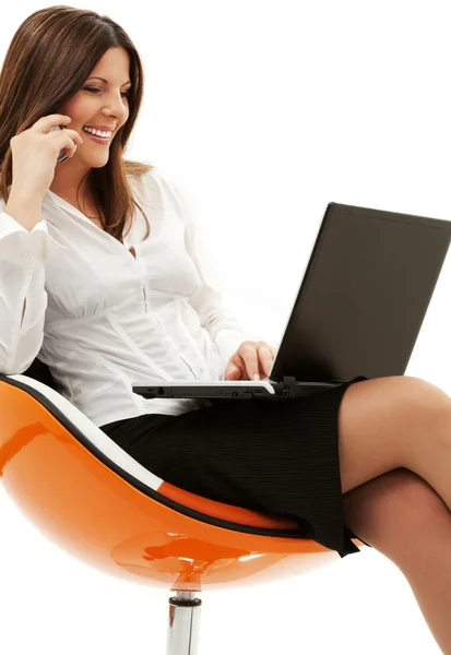 Businesswoman in chair with laptop and phone — Stock Photo, Image