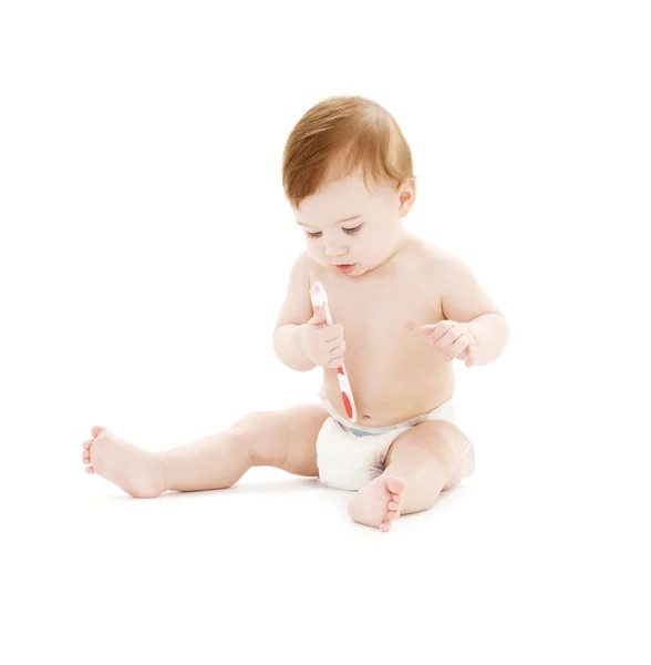 Babyjongen in luier met tandenborstel — Stockfoto