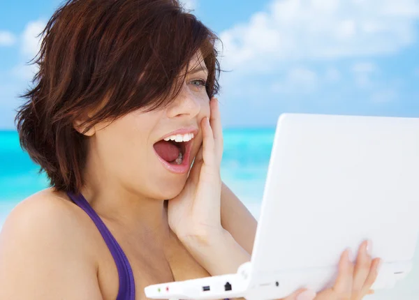 Nő a tengerparton laptop számítógéppel — Stock Fotó
