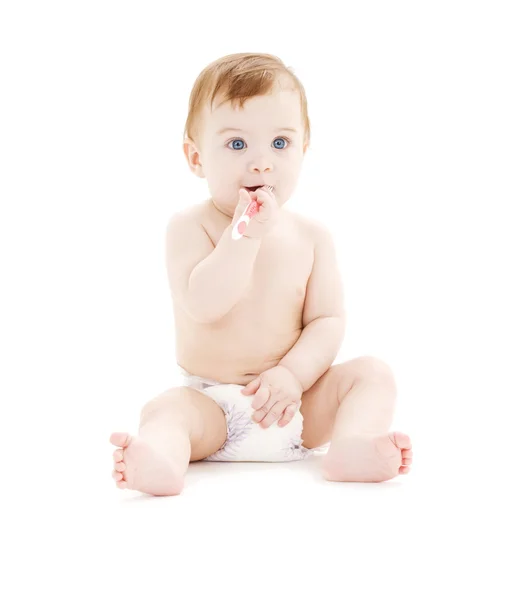 Baby boy in diaper with toothbrush — Stock Photo, Image