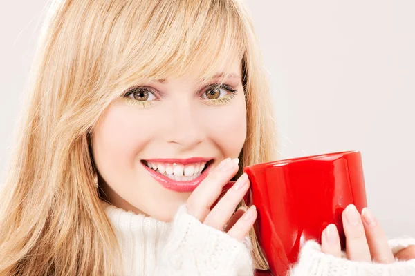 Happy teenage girl with red mug — Stock Photo, Image