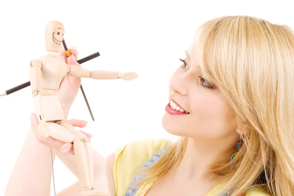 Happy teenage girl with wooden model dummy Royalty Free Stock Photos