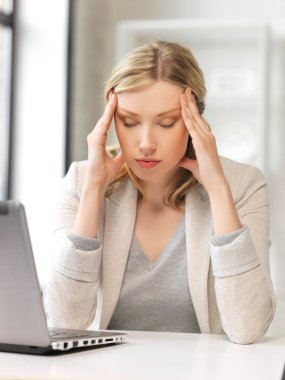 Tired woman with laptop computer clipart