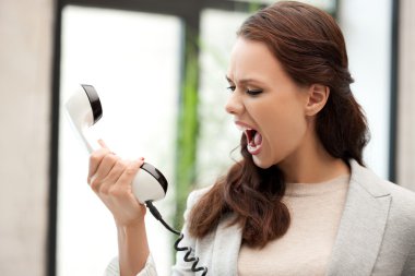 Angry businesswoman with phone clipart