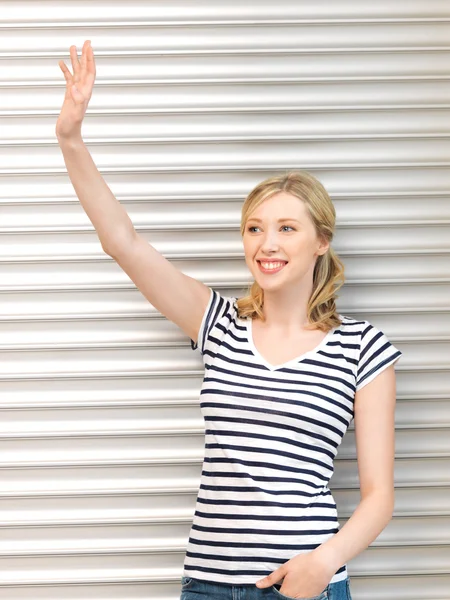 Happy teenage girl waving a greeting — Stock Photo, Image