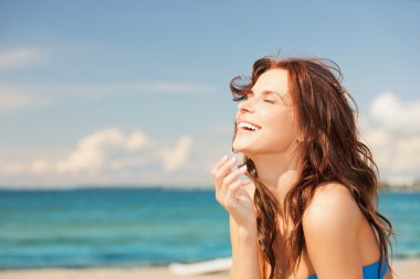 Laughing woman on the beach clipart