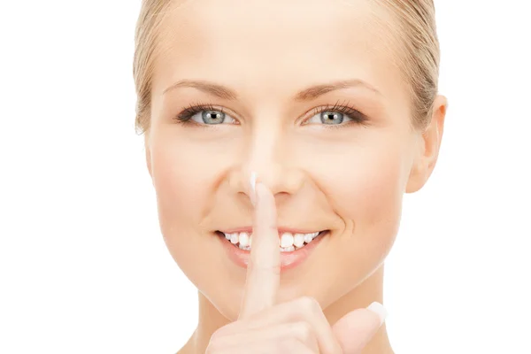 Happy woman with finger on lips — Stock Photo, Image