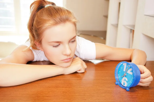 Pensive teenage girl with clock — Stock Photo, Image