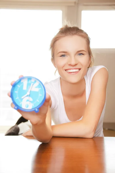 Happy and smiling teenage girl with clock — Stock Photo, Image