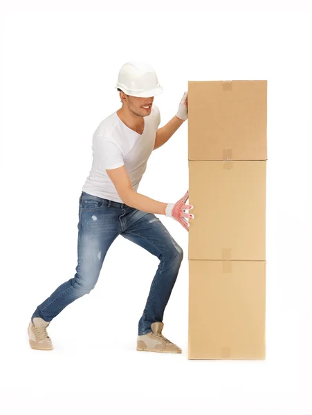 Handsome builder with big boxes — Stock Photo, Image