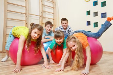 Kids on gymnastic balls clipart