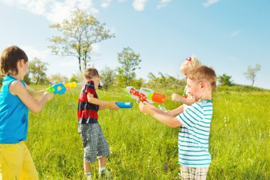 Kids group with water guns and soakers clipart