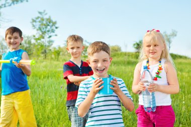 Kids group with toy water guns clipart