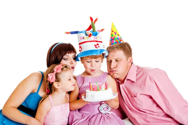 Family blowing out candles — Stock Photo, Image