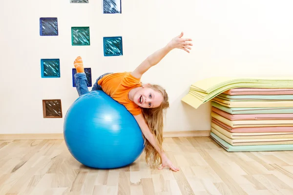 Menina em uma bola de ginástica — Fotografia de Stock